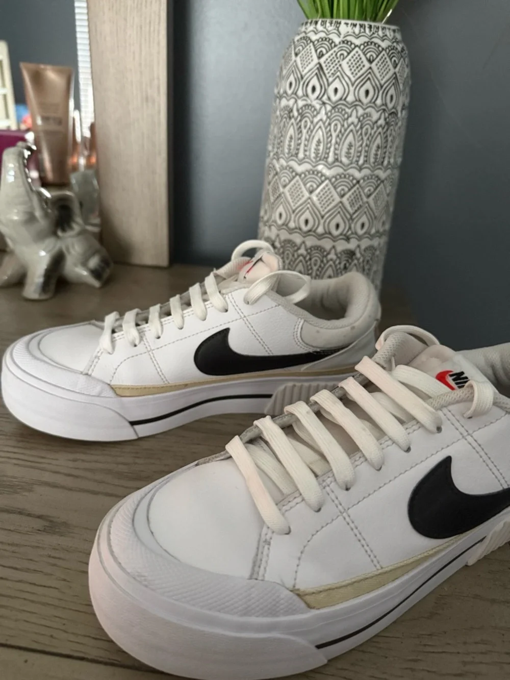 Nike White Low-Top Sneakers with Black Swoosh and Gold Accent - Picture 2 of 3